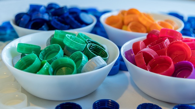 A collection of small household items a cat might ingest, such as string, hair ties, and small plastic pieces.