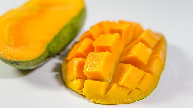 Close-up of a ripe mango showing its vibrant orange flesh and texture (can dogs have mango)